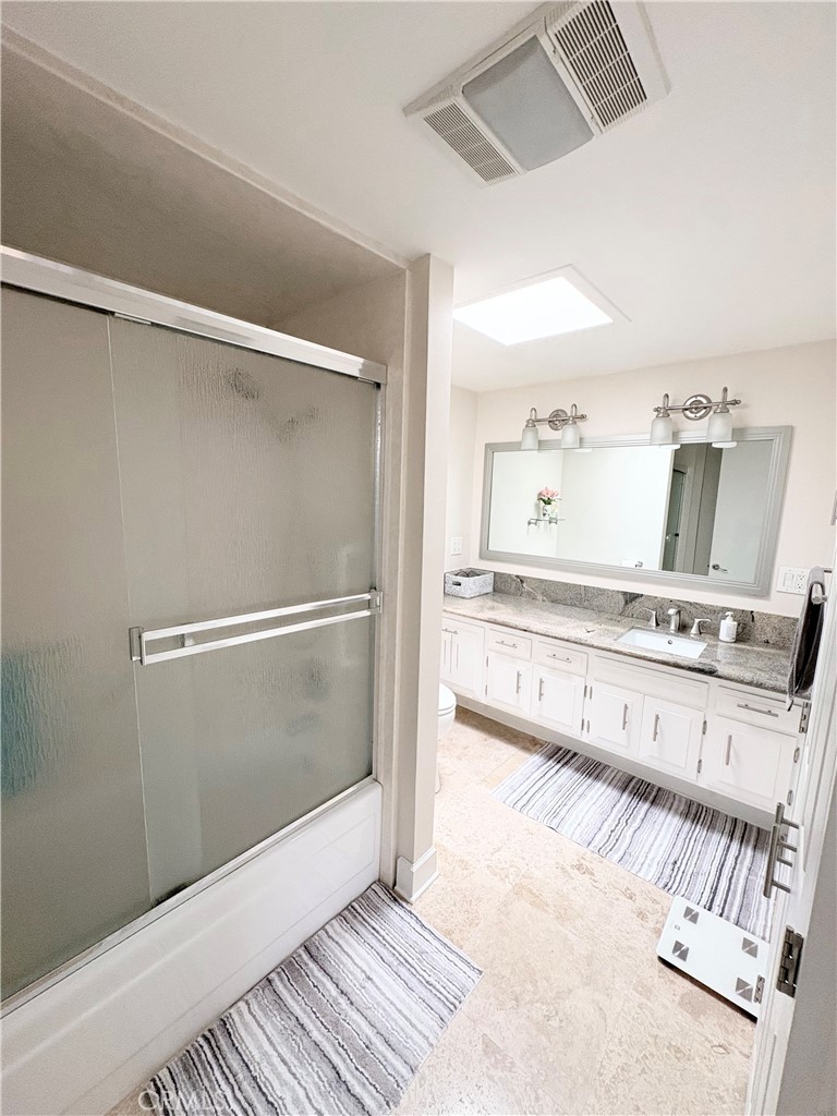 1680 Monterey Road Seal Beach, CA 90740 - Photo 14 of 19 a bathroom with a double vanity sink and mirror