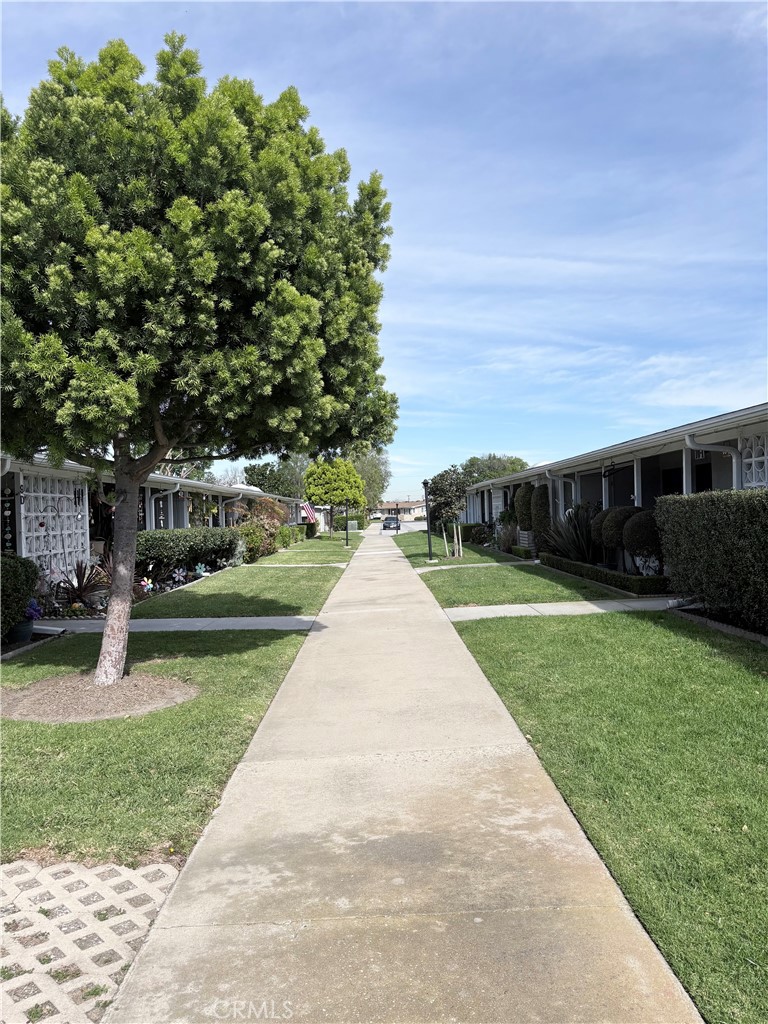 1680 Monterey Road Seal Beach, CA 90740 - Photo 2 of 19 a view of house with garden and tall trees