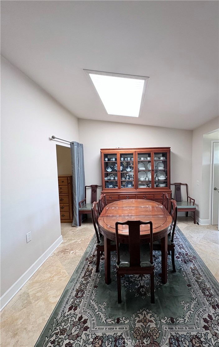1680 Monterey Road Seal Beach, CA 90740 - Photo 5 of 19 a dining room with a wooden table and chairs
