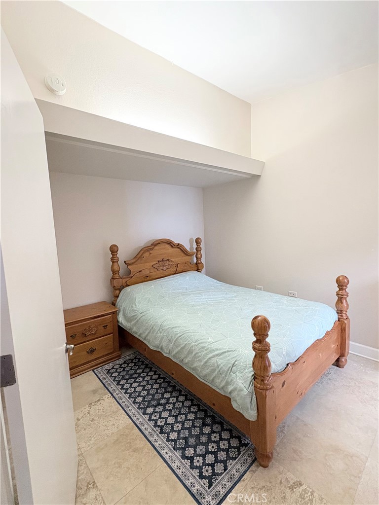 1680 Monterey Road Seal Beach, CA 90740 - Photo 8 of 19 a bedroom with a bed and a table