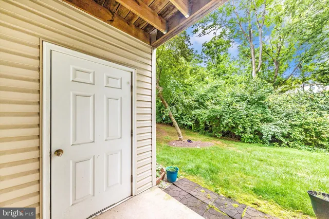 a view of a backyard with plants and a porch
