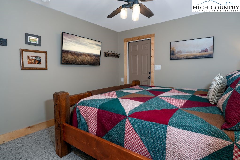 25 Red Oak Road Newland, NC 28657 - Photo 35 of 45 a bedroom with a bed and a chandelier