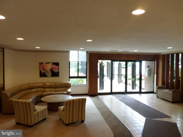 a living room with furniture and large windows