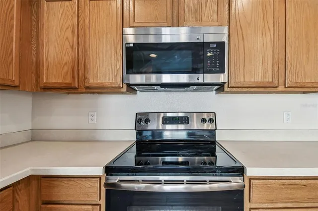 a bedroom with a bed couch and windows