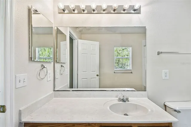 a bedroom with a bed and a mirror