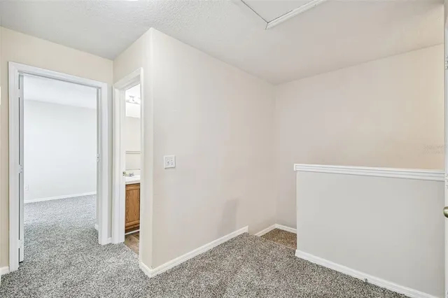an aerial view of a house with garden space and street view