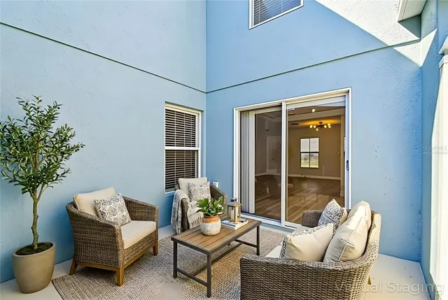 an aerial view of a houses with a garden and lake view