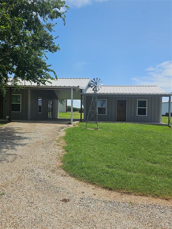 a view of a house with a yard and sitting area