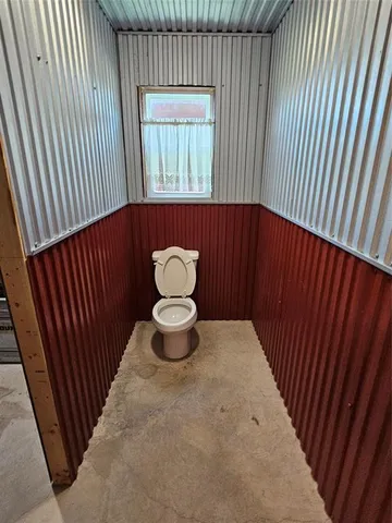 a view of a house with a patio and a yard