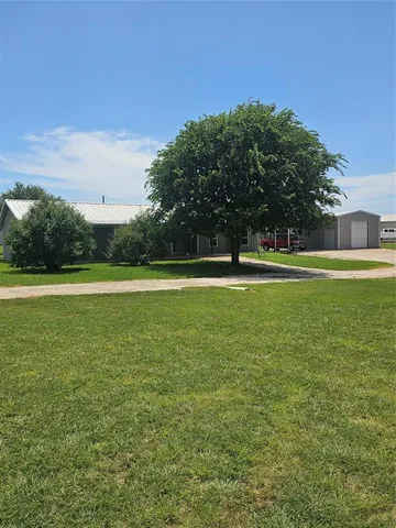 a view of a green field with clear sky