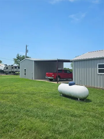 a view of a backyard with table and chairs and potted plants