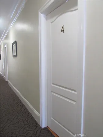 a view of empty room with wooden floor and window