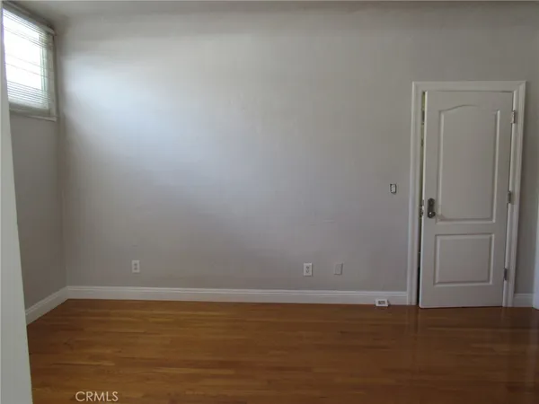 a kitchen with white cabinets and appliances