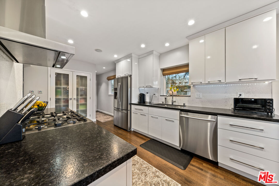95 Anita Drive Pasadena, CA 91105 - Photo 13 of 31 a kitchen with stainless steel appliances granite countertop a sink stove and refrigerator