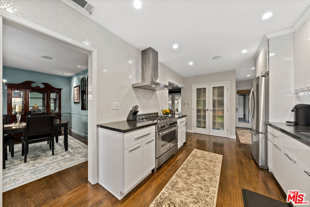 95 Anita Drive Pasadena, CA 91105 - Photo 14 of 31 a kitchen with stainless steel appliances granite countertop sink stove and refrigerator