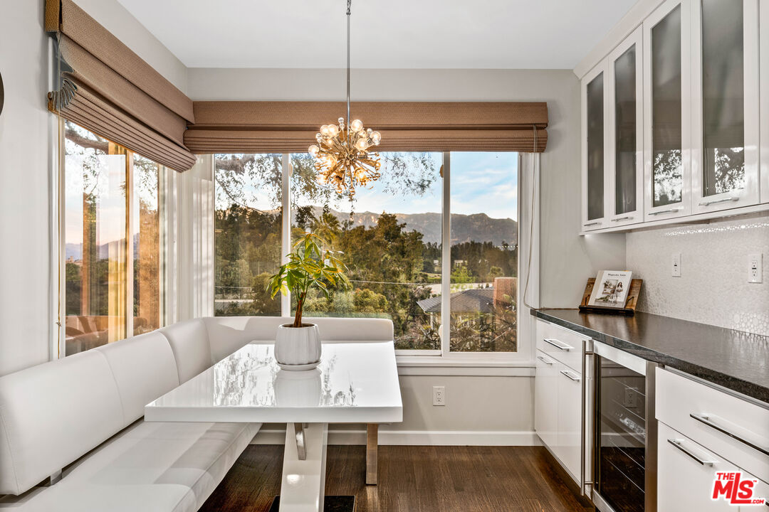 95 Anita Drive Pasadena, CA 91105 - Photo 16 of 31 a living room with large windows and chandelier