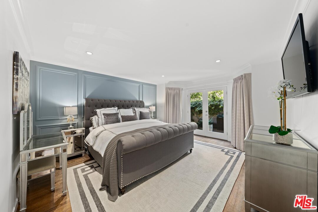 95 Anita Drive Pasadena, CA 91105 - Photo 18 of 31 a bedroom with a large bed and a flat tv screen on dresser