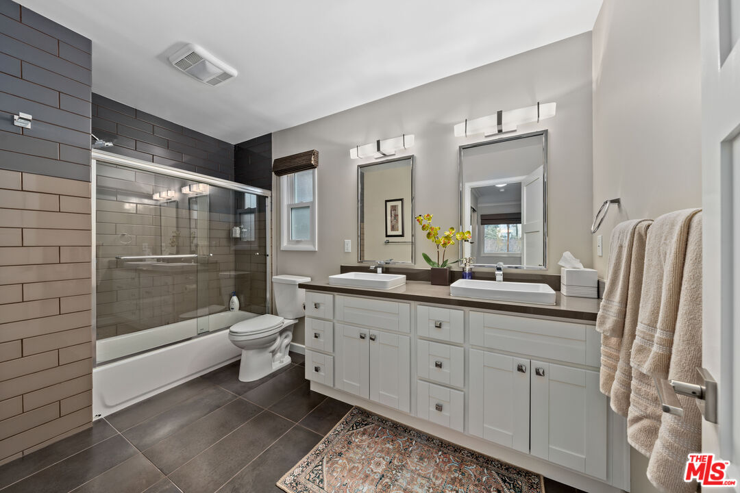 95 Anita Drive Pasadena, CA 91105 - Photo 22 of 31 a bathroom with a double vanity sink a toilet and shower