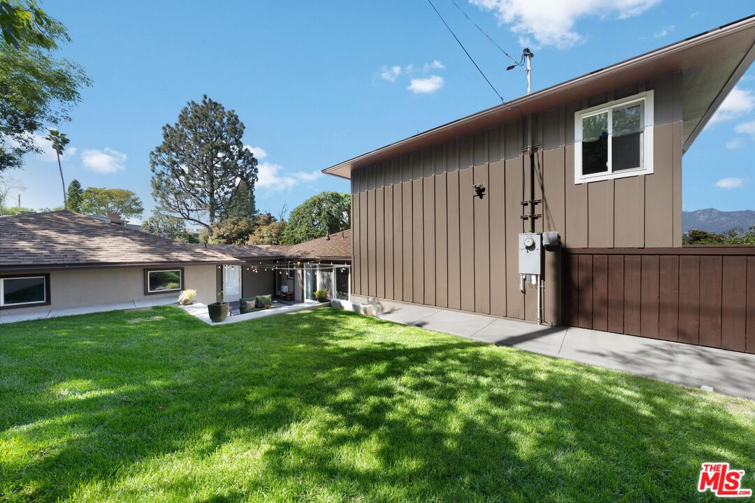 95 Anita Drive Pasadena, CA 91105 - Photo 29 of 31 a backyard of a house with table and chairs