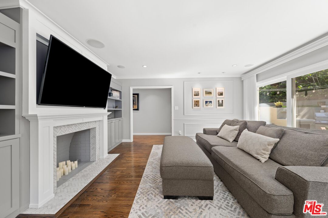 95 Anita Drive Pasadena, CA 91105 - Photo 10 of 31 a living room with furniture a fireplace and a flat screen tv