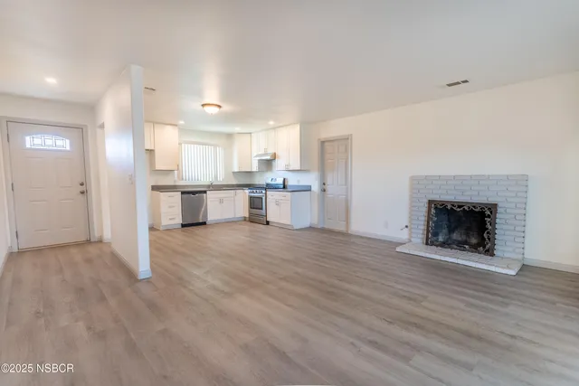 a view of kitchen with sink and fireplace