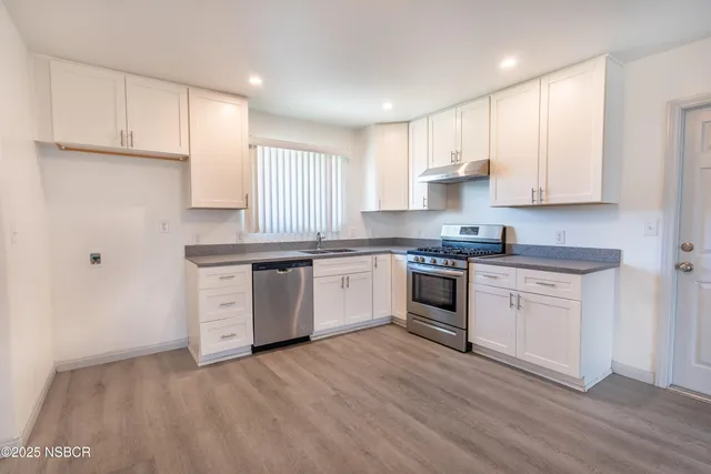 a view of a kitchen with a sink cabinets and a fireplace