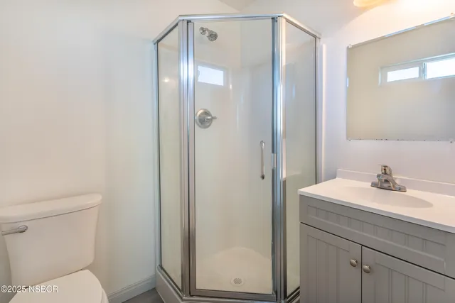 a bathroom with a sink a toilet and vanity