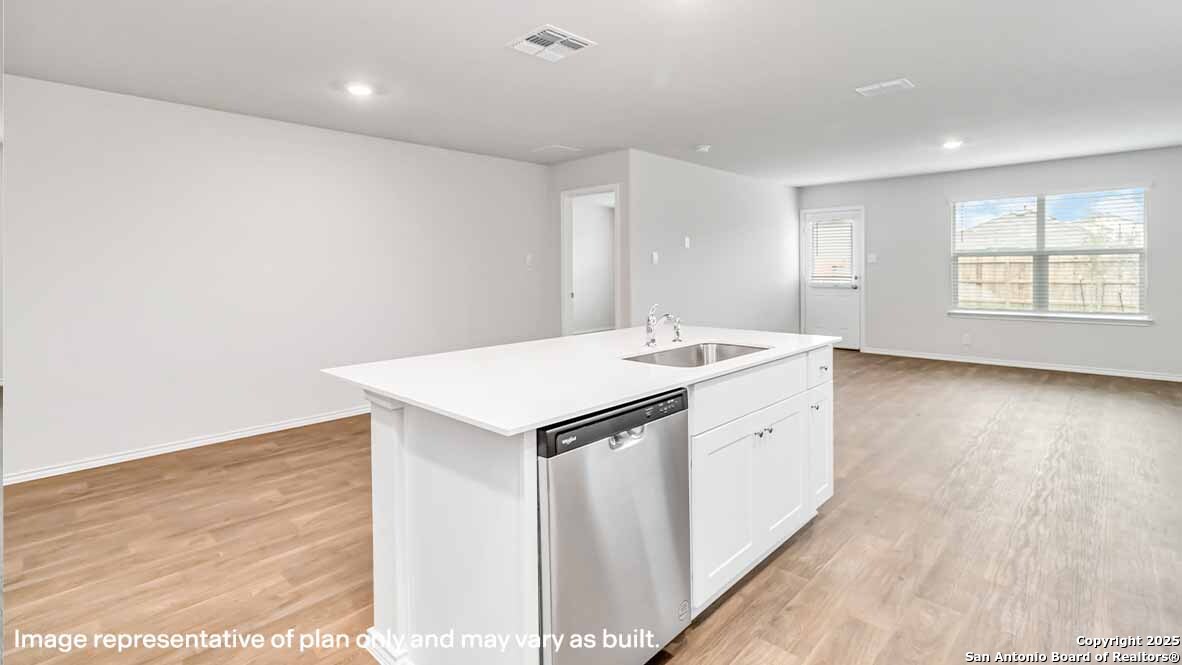 14731 Clay Rdg Run San Antonio, TX 78253 - Photo 12 of 55 a utility room with a sink dishwasher and wooden floor