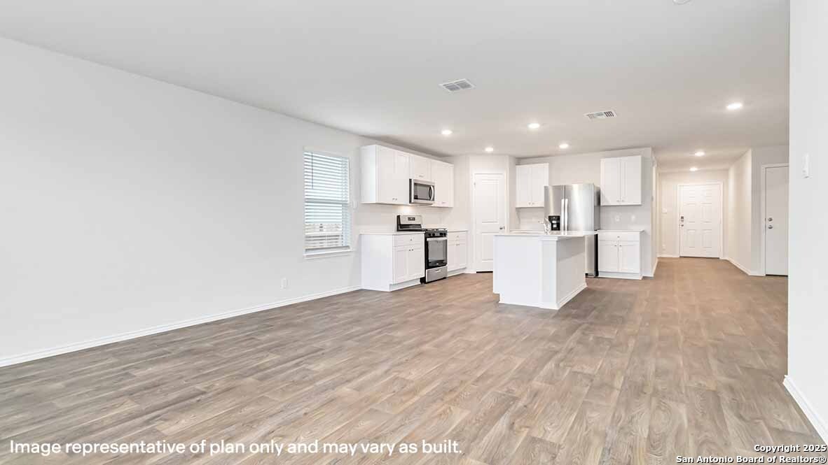 14731 Clay Rdg Run San Antonio, TX 78253 - Photo 13 of 55 a view of a kitchen with wooden floor and windows