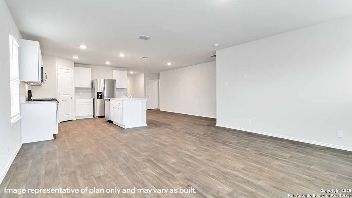 14731 Clay Rdg Run San Antonio, TX 78253 - Photo 14 of 55 a view of a kitchen with a refrigerator and a microwave