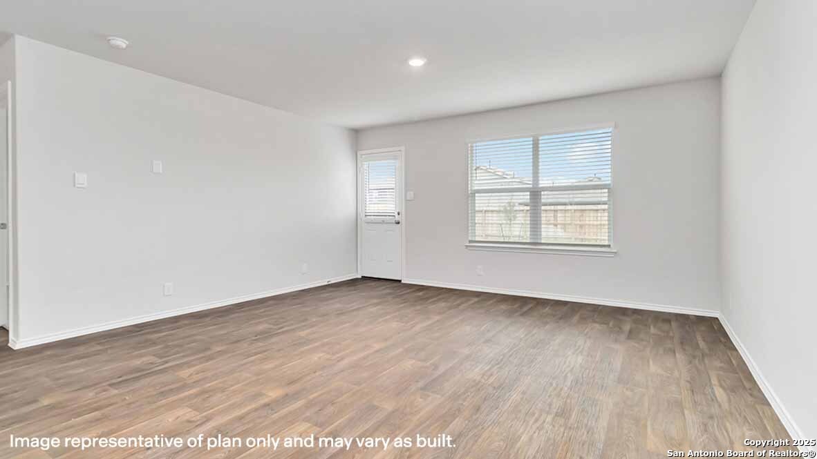 14731 Clay Rdg Run San Antonio, TX 78253 - Photo 16 of 55 an empty room with wooden floor and windows