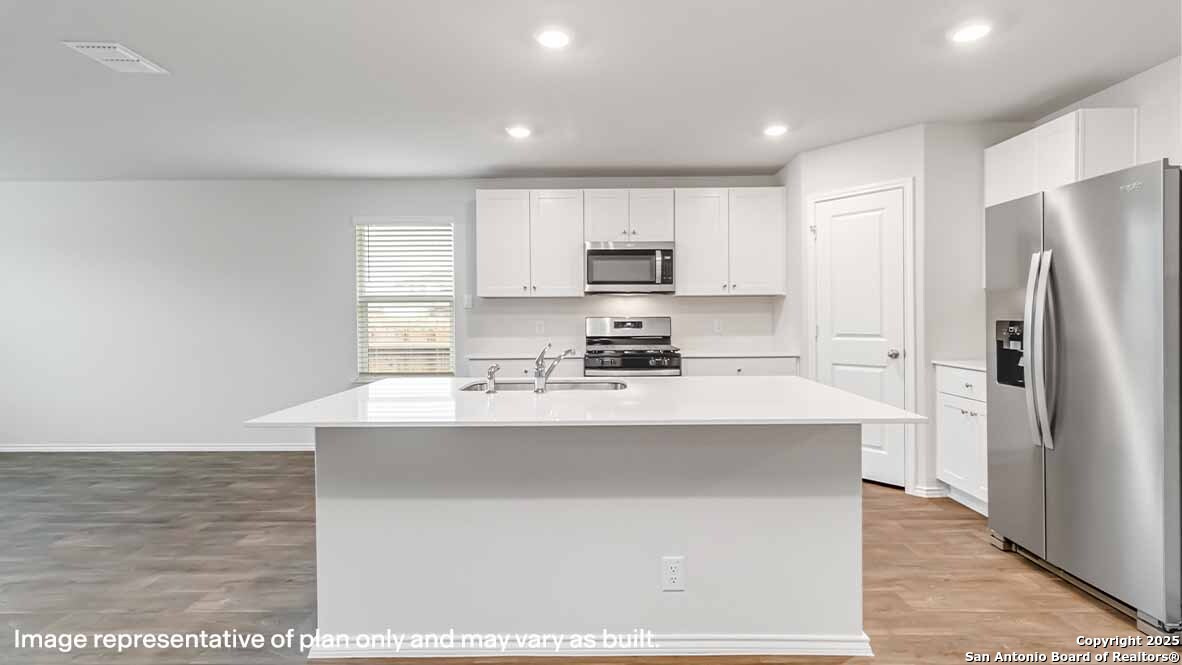 14731 Clay Rdg Run San Antonio, TX 78253 - Photo 5 of 55 a kitchen with kitchen island a sink stainless steel appliances and cabinets