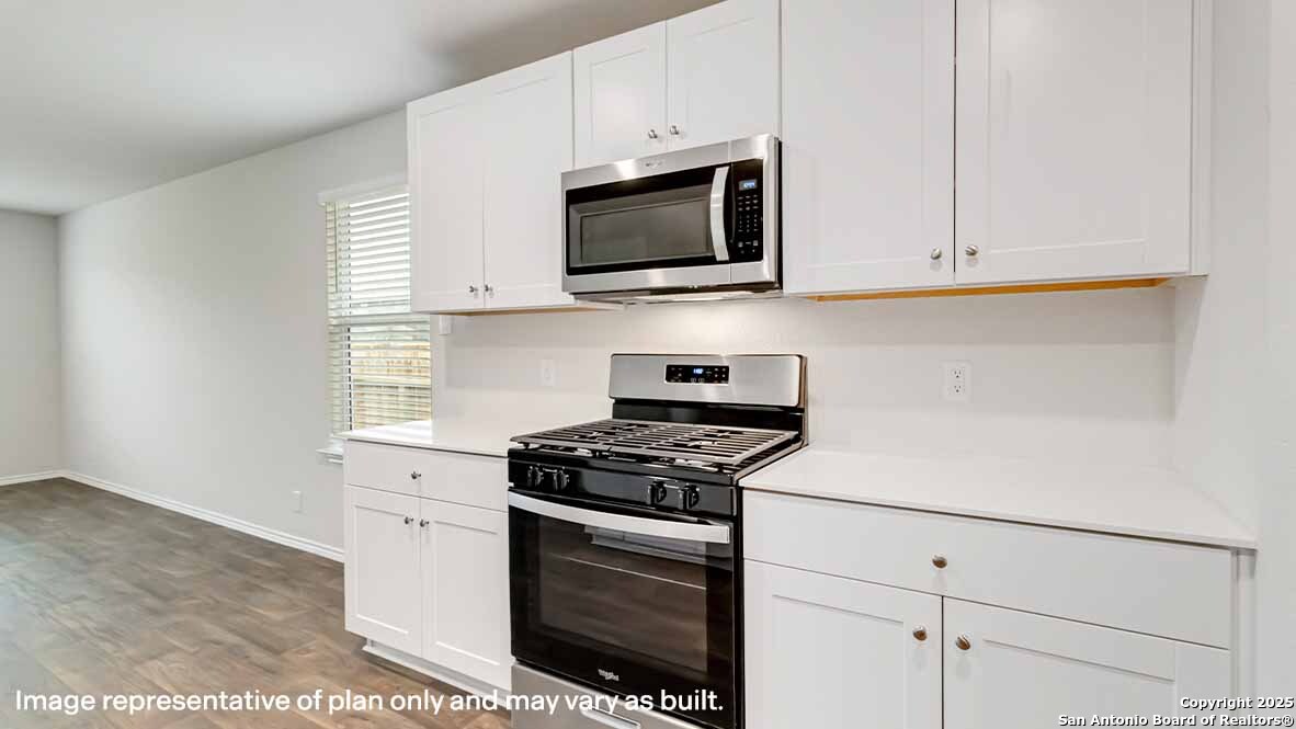 14731 Clay Rdg Run San Antonio, TX 78253 - Photo 9 of 55 a kitchen with white cabinets stainless steel appliances and sink
