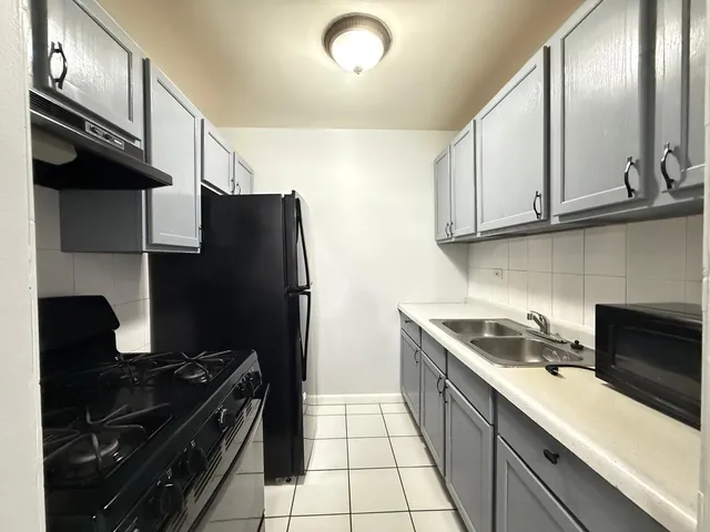 a kitchen with a sink and a refrigerator