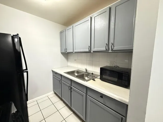 a kitchen with a sink and a refrigerator