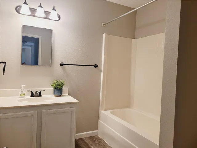 a bathroom with a sink mirror and toilet