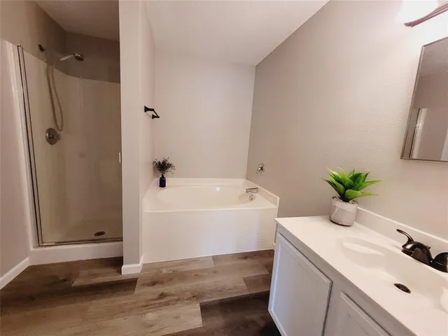 a bathroom with a tub and shower