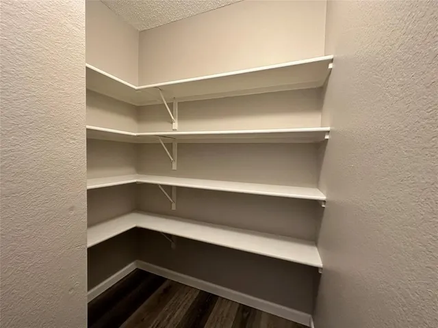 an empty room with a window and a ceiling fan