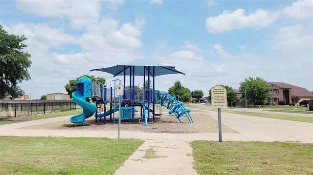 a view of a park with swings and slides