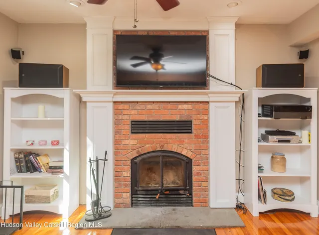 a living room with fireplace furniture and a flat screen tv