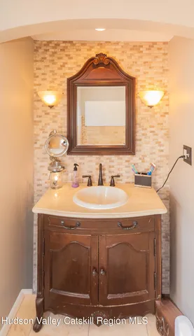a bathroom with a sink mirror and vanity