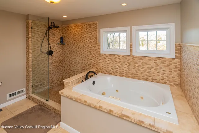 a bathroom with a bath tub and shower