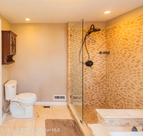 a bathroom with a toilet and a shower