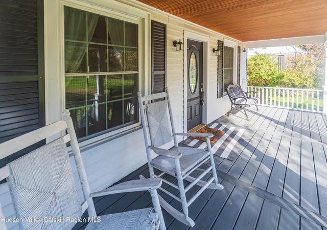 a balcony with table and chairs