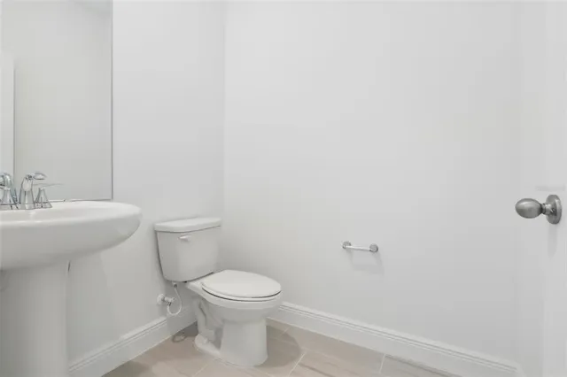 a white toilet sitting next to a white sink