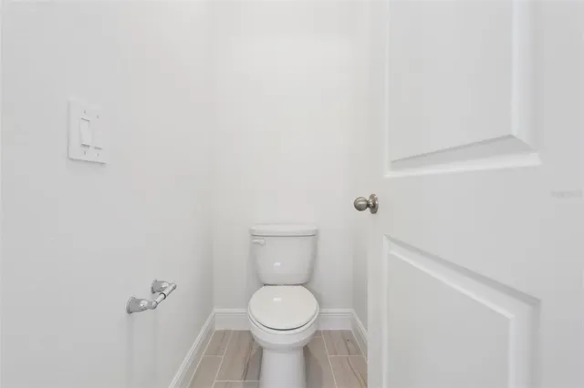 a white toilet sitting next to a white sink