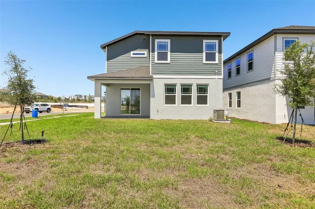 a view of a house with backyard and garden