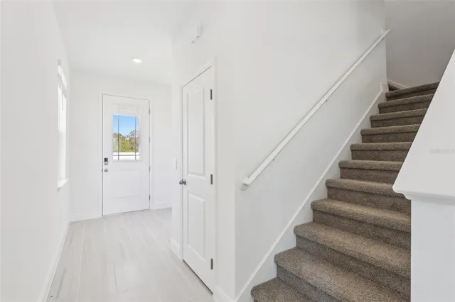 a view of staircase with white walls