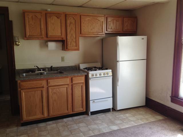706 West Front Street Bloomington, IL 61701 - Photo 2 of 2 a kitchen with appliances a refrigerator and cabinets