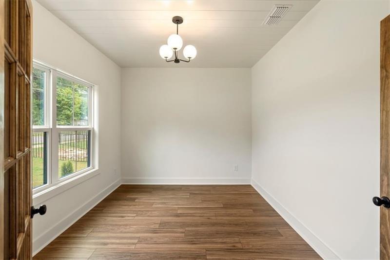 131 Old Alabama Road Southeast Emerson, GA 30137 - Photo 8 of 44 a view of empty room with wooden floor and fan